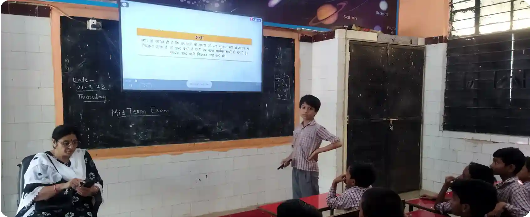 Students exploring NCERT books in Hindi displayed on iPrep implemented in a smart board in a hindi medium classroom