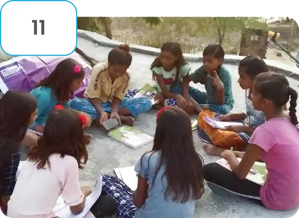 Girls using the iPrep app on a mobile device in a rural setting, showcasing community-driven adoption of mobile app received through a social sector education program
