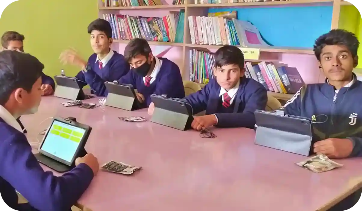 Students in Kashmir engaged with tablets in an ICT lab implemented by iDream Education under a CSR educational program supported by PowerGrid.